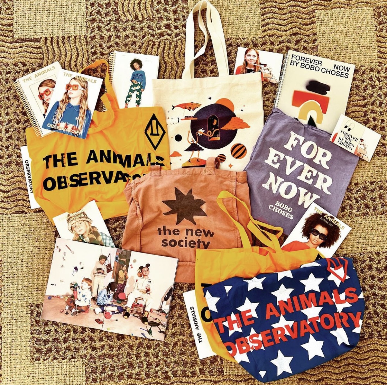 Charlie & Lu collection of lookbooks & tote bags after visiting Playtime Paris & Pitti Bimbo January 2022.